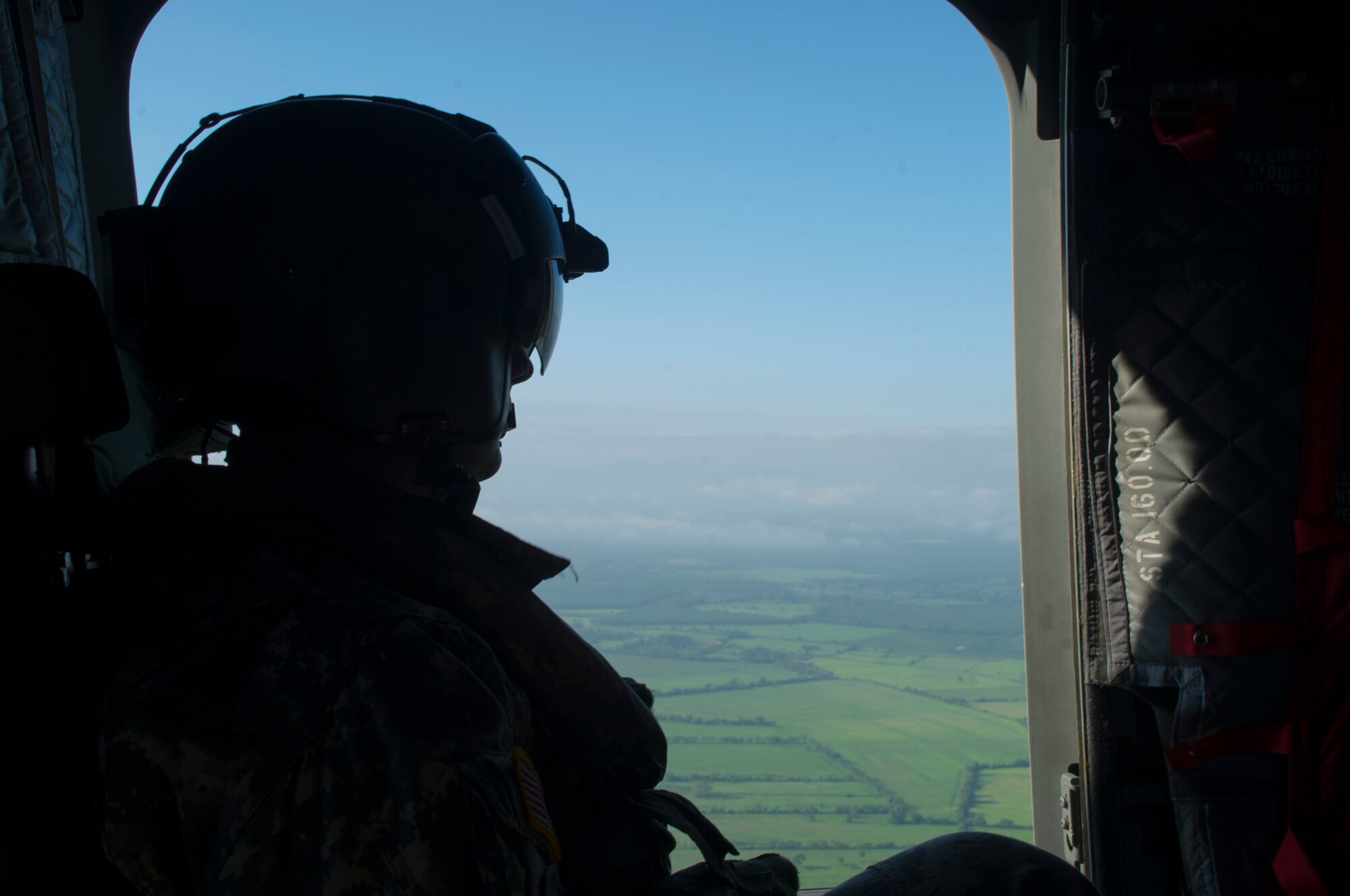 David Uplinger 1-228th Aviation Regiment flight engineer watches the landscape slip by the door of a U.S. Army CH-47 Chinook Dec. 17, 2015, as the aircraft flies over the Gracias a Dios Department (state) of Honduras. The aircraft provided airlift for Honduran troops to help support a request for assistance from the Honduran president in October 2014, to help disrupt the flow of drugs in the region. (U.S. Air Force photo by Capt. Christopher Mesnard/Released)