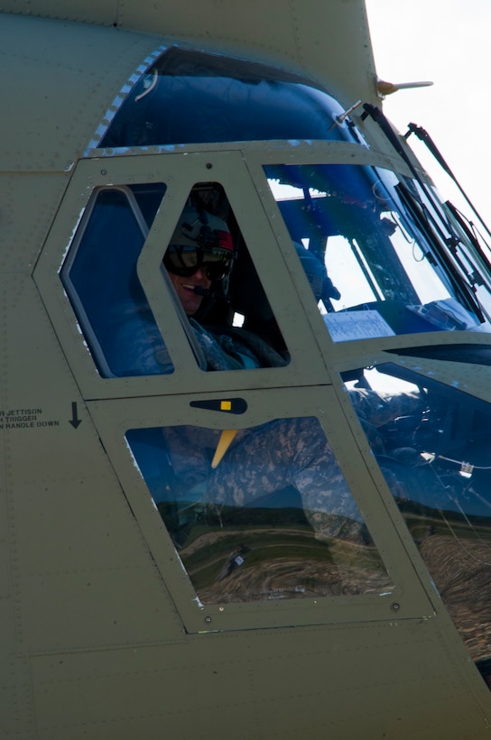 U.S. Army Chief Warrant Officer 3 Kyle Johnson, 1-228th Aviation Regiment pilot prepares to take off in a U.S. Army CH-47 Chinook Dec. 17, 2015, in the Gracias a Dios Department (state) of Honduras. (SOLDIERS NAME) is one of several aviators who helped airlift Honduran troops and supplies during the two-day mission, allowing the Hondurans to better move in a remote area they are making significant progress in disrupting the flow of illicit drugs and materials. (U.S. Air Force photo by Capt. Christopher Mesnard/Released)