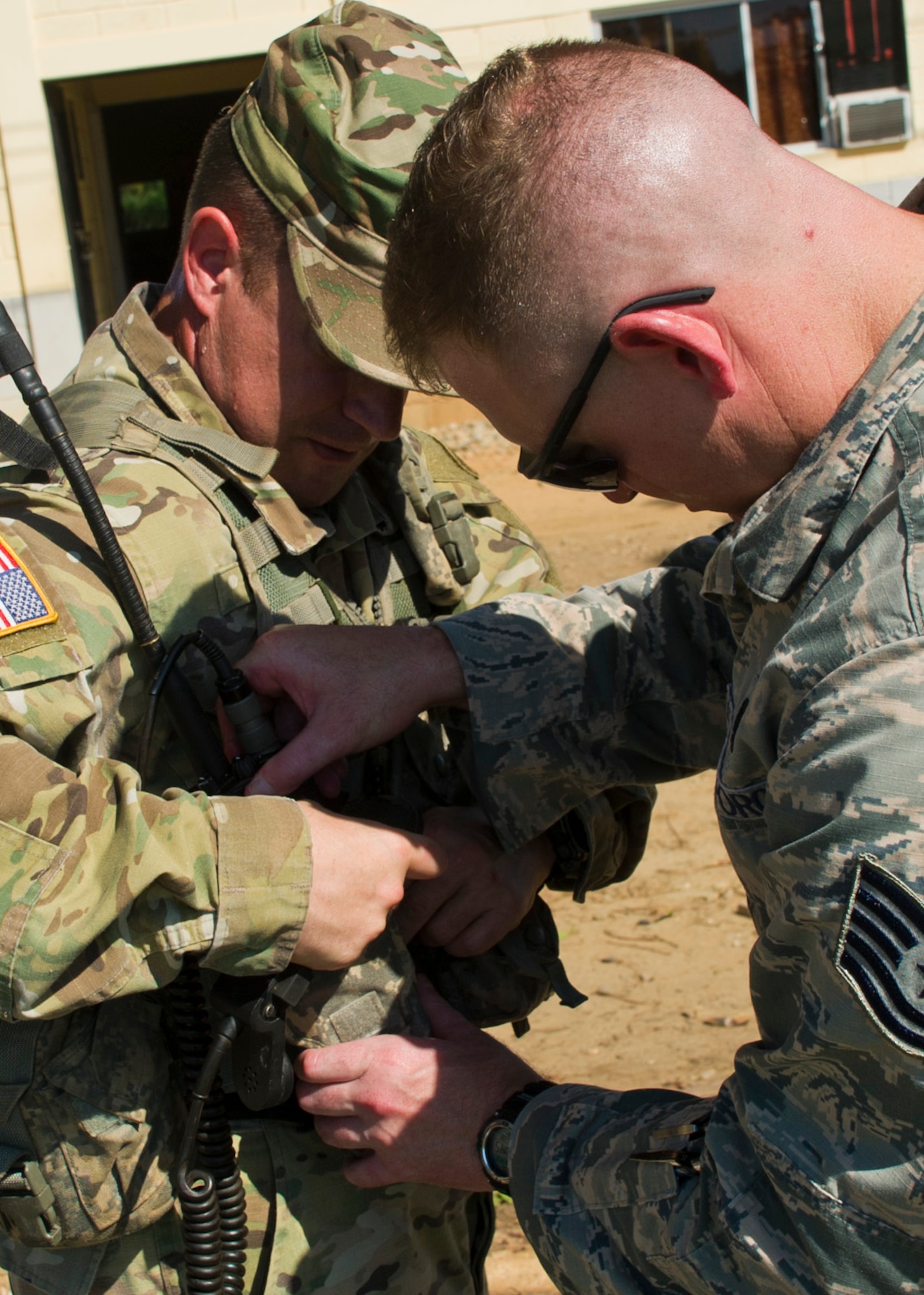 U.S. Air Force Tech. Sgt. Wesley Thaxton, Joint Task Force-Bravo radio operator, helps U.S. Army Capt. John Dills, JTF-Bravo tactical officer in charge, set up his communications for a Honduran troop movement they helped support Dec. 16, 2015, in the Gracias a Dios Department (state) of Honduras. The U.S. personnel served as a key liaison between the U.S. airlift Honduran ground forces, as they transported Honduran soldiers to remote areas of the department, to help disrupt the flow of illicit drugs and materials through the area. (U.S. Air Force photo by Capt. Christopher Mesnard/Released)