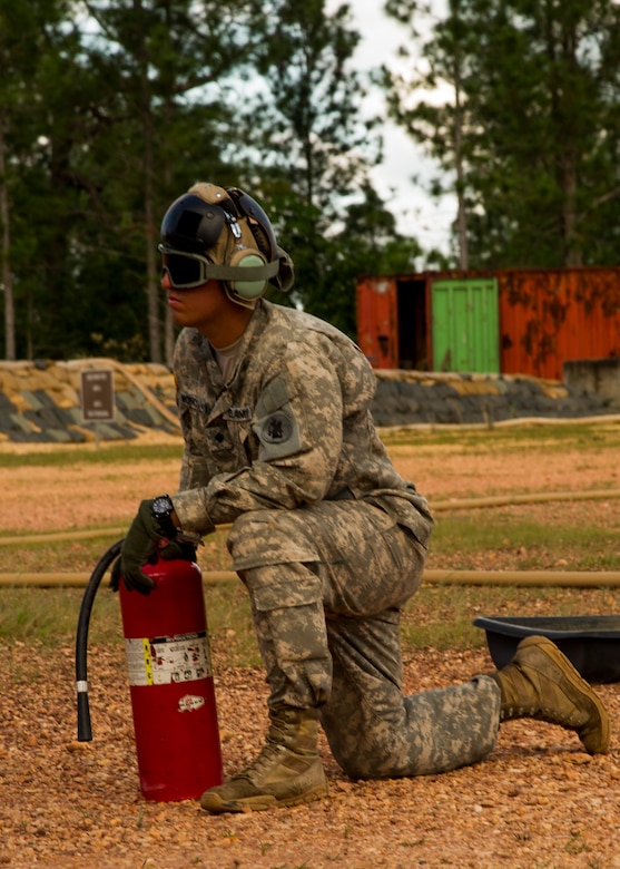 U.S. Army Cpl. Randy Moncivaiz, Joint Task Force-Bravo Petroleum, Oil and Lubricant team leader provides a safety over watch while a U.S. Army CH-47 Chinook is refueled Dec. 17, 2015, at Mocoron Airfield in the Gracias a Dios Department (state) of Honduras. The airfield provides the flying forces a hub to refuel at and embark from when conducting CARAVANA troop movements in the area. The troop movements are part of a combined U.S. and Honduran effort to limit the flow of illicit drugs and materials through the region. (U.S. Air Force photo by Capt. Christopher Mesnard/Released)