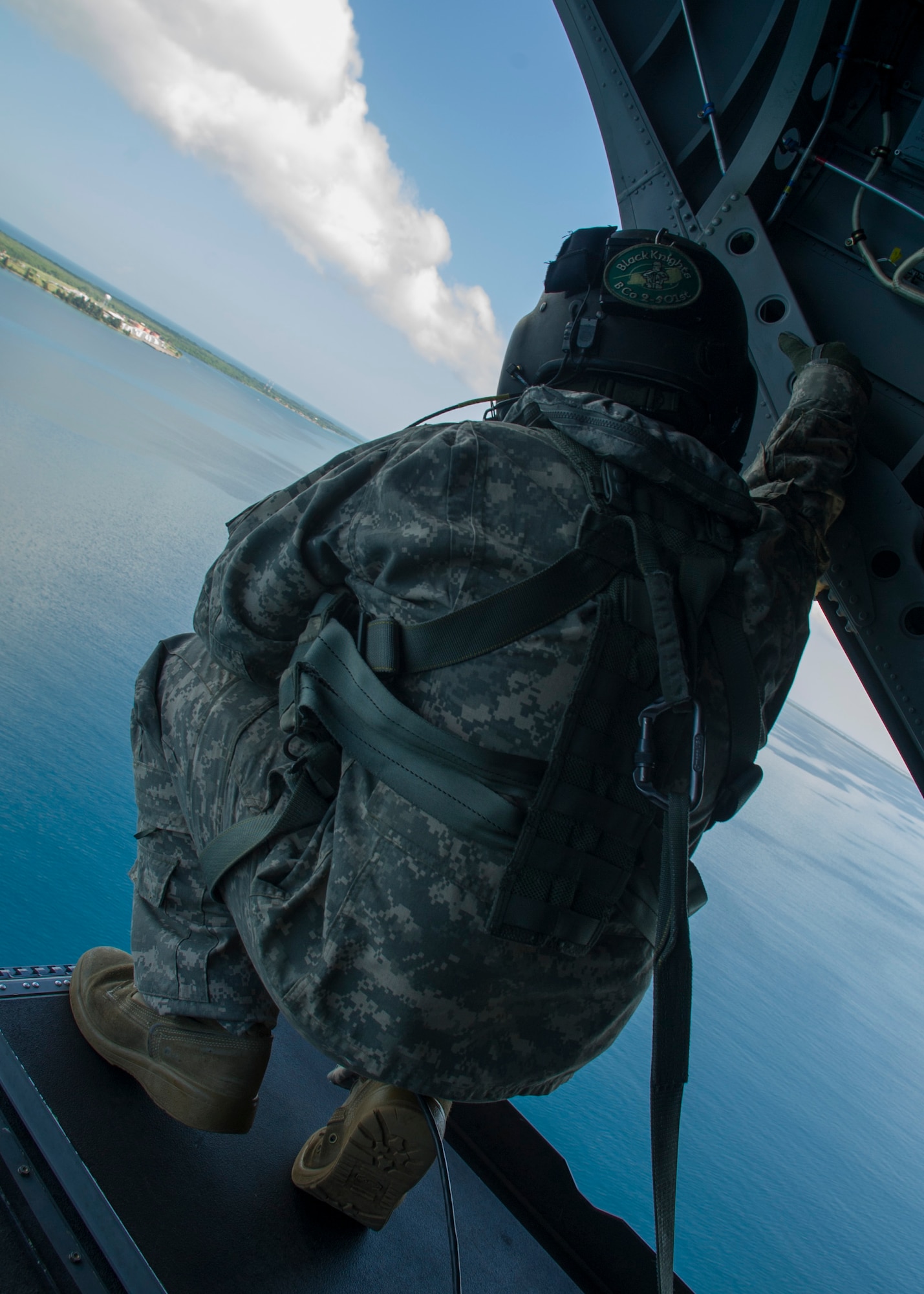 U.S. Army Sgt. David Pressnell, 1-228th Aviation Regiment flight engineer provides visual aid to his fellow U.S. Army CH-47 Chinook aircrew as the helicopter departs a Honduran base Dec. 17, 2015, in the Gracias a Dios Department (state) of Honduras. The CH-47 served as a transport for Honduran troops traveling to and from various outposts in the remote region to help disrupt the flow of illicit materials. (U.S. Air Force photo by Capt. Christopher Mesnard/Released)