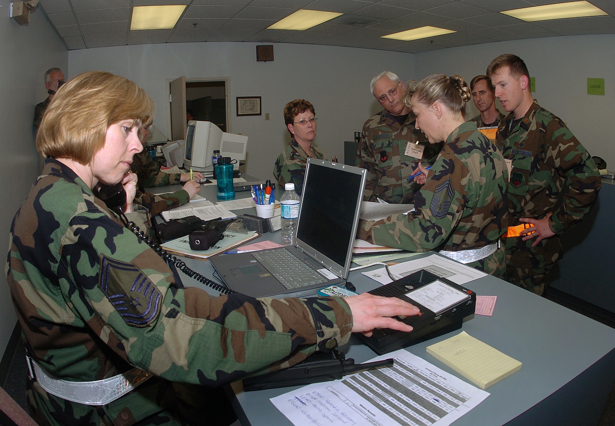 Senior Master Sgt. Jean Allen, assigned to the 142nd Fighter Wing Mission Support Group, left, assist in processing unit personnel during an Operational Readiness Exercise, June 4, 2006, Portland Air National Guard Base, Ore.  Allen retired with more than 32 years of service on Dec. 22, 2015. (Air National Guard photo by Tech. Sgt. John Hughel, 142nd Fighter Wing Public Affairs)