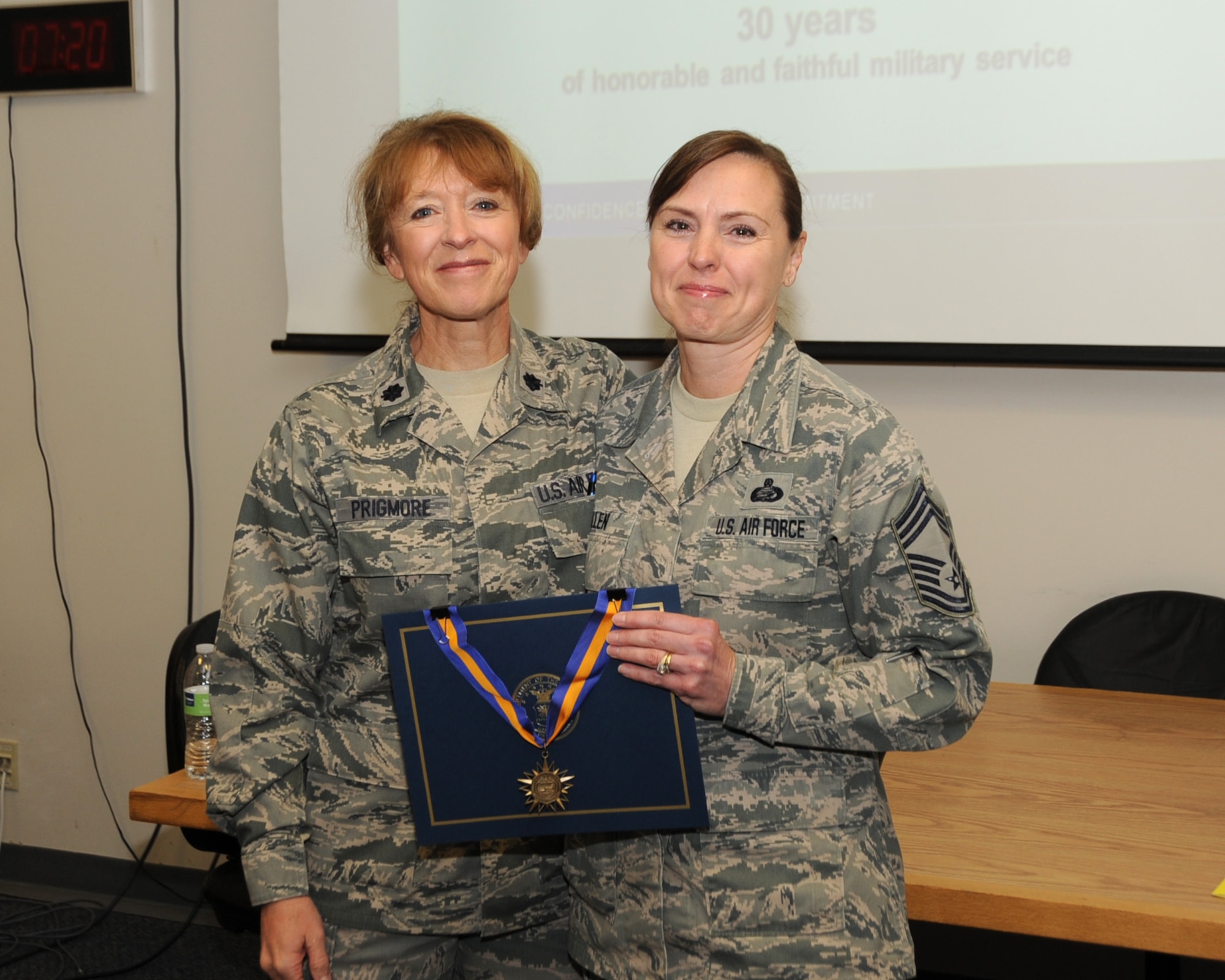 Chief Master Sgt. Jean Allen receives recognition for 30 years of dedicated service from the Commander of the 142nd Force Support Squadron, Col. Donna Prigmore, Portland Air National Guard Base, Ore., Nov. 2, 2013. (Air National Guard photo by Master Sgt. Shelly Davison, 142nd Fighter Wing Public Affairs)