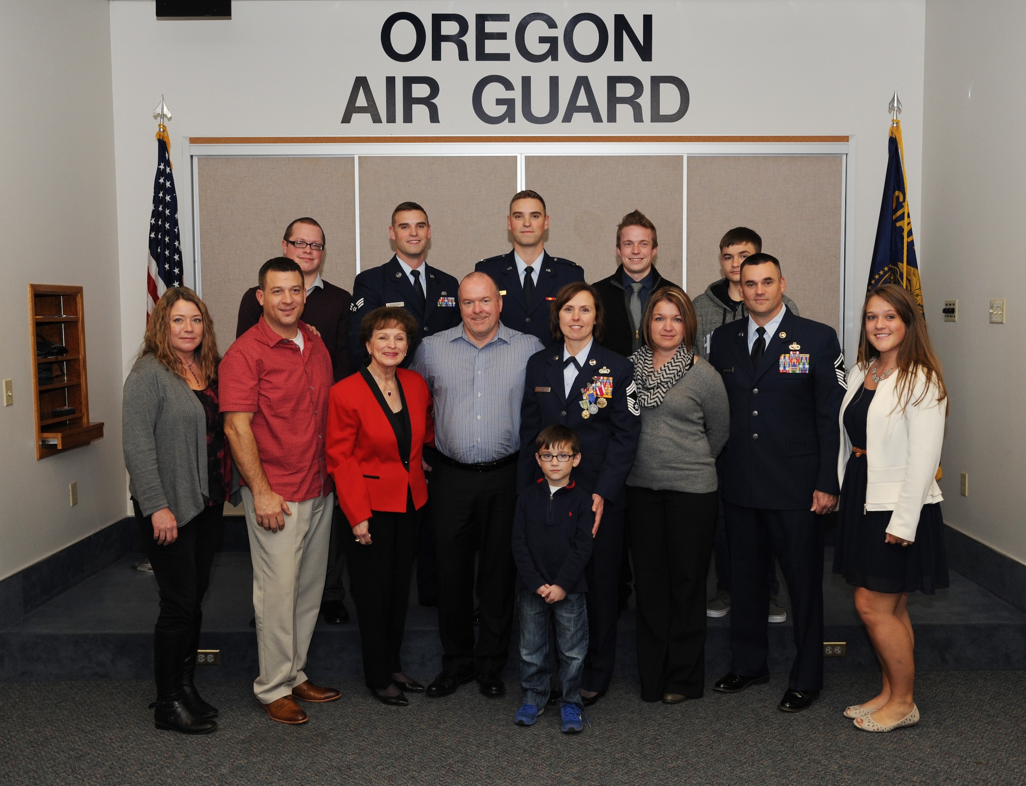 Family members of Chief Master Sgt. Jean Allen gather for a photograph following her formal retirement ceremony, Dec. 22, 2015, Portland Air National Guard Base, Ore. (Air National Guard photo by Tech. Sgt. John Hughel, 142nd Fighter Wing Public Affairs)