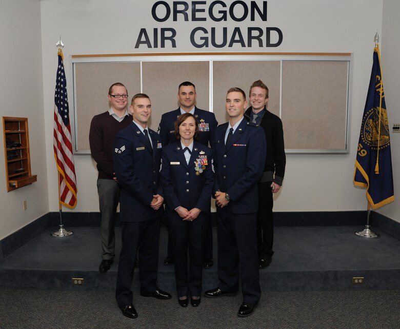 Chief Master Sgt. Jean Allen, center, poses for a photograph with her five sons following her formal retirement ceremony from the Oregon Air National Guard, Dec. 22, 2015, Portland Air National Guard Base, Ore. (Left to right) Jared Ellis, Senior Airman Chris Anderson, Senior Master Sgt. Jason Anderson, 2nd Lt. Jake Anderson and Logan Ellis. (Air National Guard photo by Tech. Sgt. John Hughel, 142nd Fighter Wing Public Affairs)