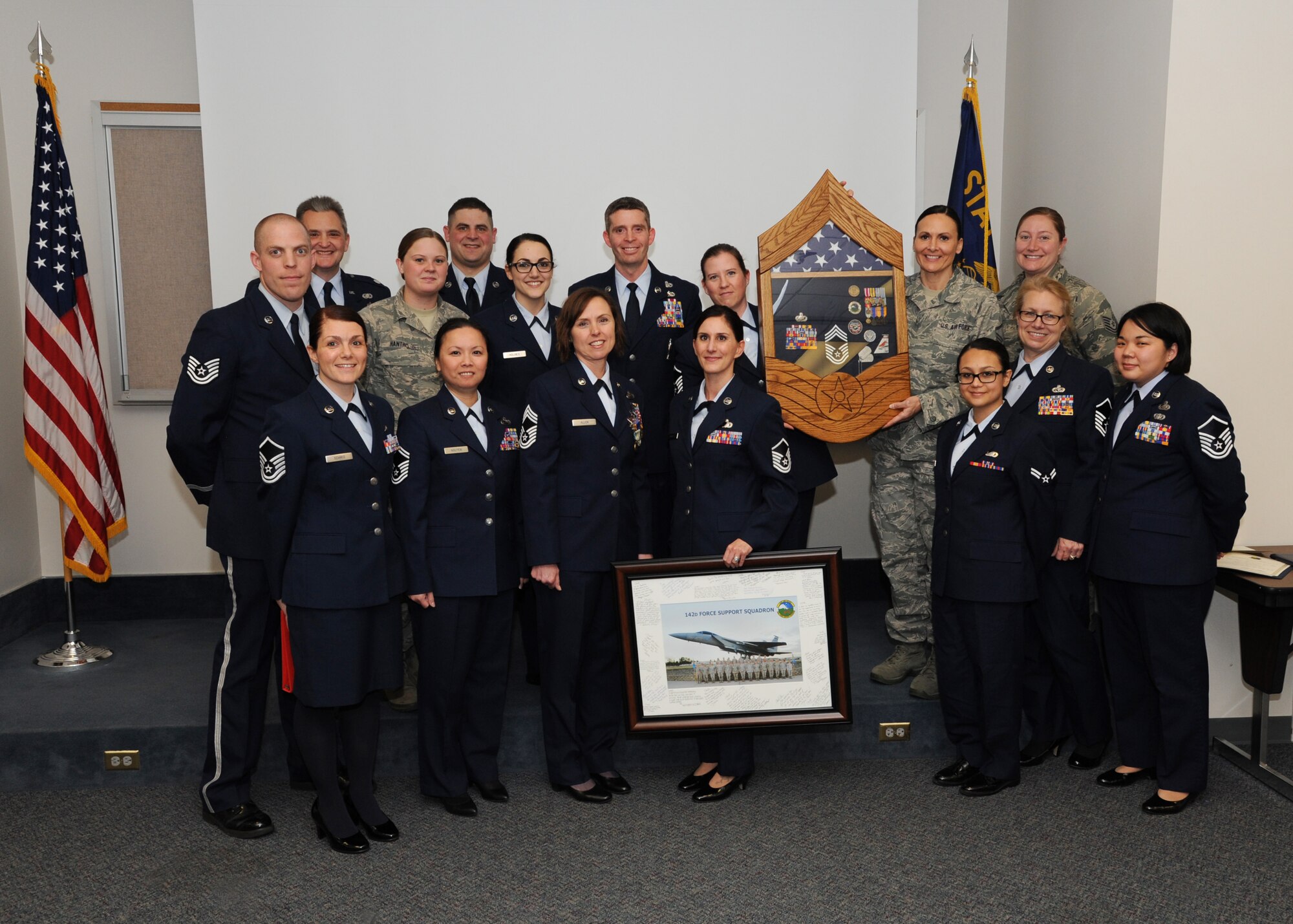 Members of the 142nd Fighter Wing Force Support Squadron gather for a group photograph after presenting several awards of recognition to Chief Master Sgt. Jean Allen, (center front row) during her retirement ceremony, Dec. 22, 2015, Portland Air National Guard Base, Ore. (Air National Guard photo by Tech. Sgt. John Hughel, 142nd Fighter Wing Public Affairs)