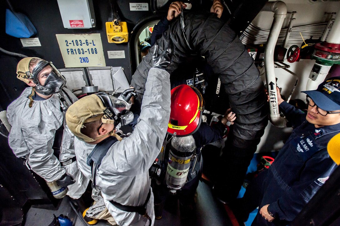 U.S. sailors participate in simulated toxic gas casualty training aboard the USS Ronald Reagan near Yokosuka, Japan, Dec. 26, 2015. The Ronald Reagan provides a combat-ready force that protects and defends interests of  allies and partners in the Indo-Asia-Pacific region. U.S. Navy photo by Petty Officer 3rd Class Nathan Burke