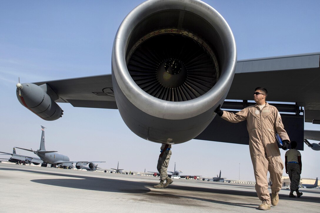U.S. Air Force Maj. Steve Briones performs an inspection of a KC-135 Stratotanker before conducting a mission in support of Operation Inherent Resolve on Al Udeid Air Base, Qatar, Dec. 22, 2015. Briones is a pilot assigned to the 340th Expeditionary Air Refueling Squadron, deployed out of the 351st Air Refueling Squadron in RAF Mildenhall, England. U.S. Air Force photo by Staff Sgt. Corey Hook