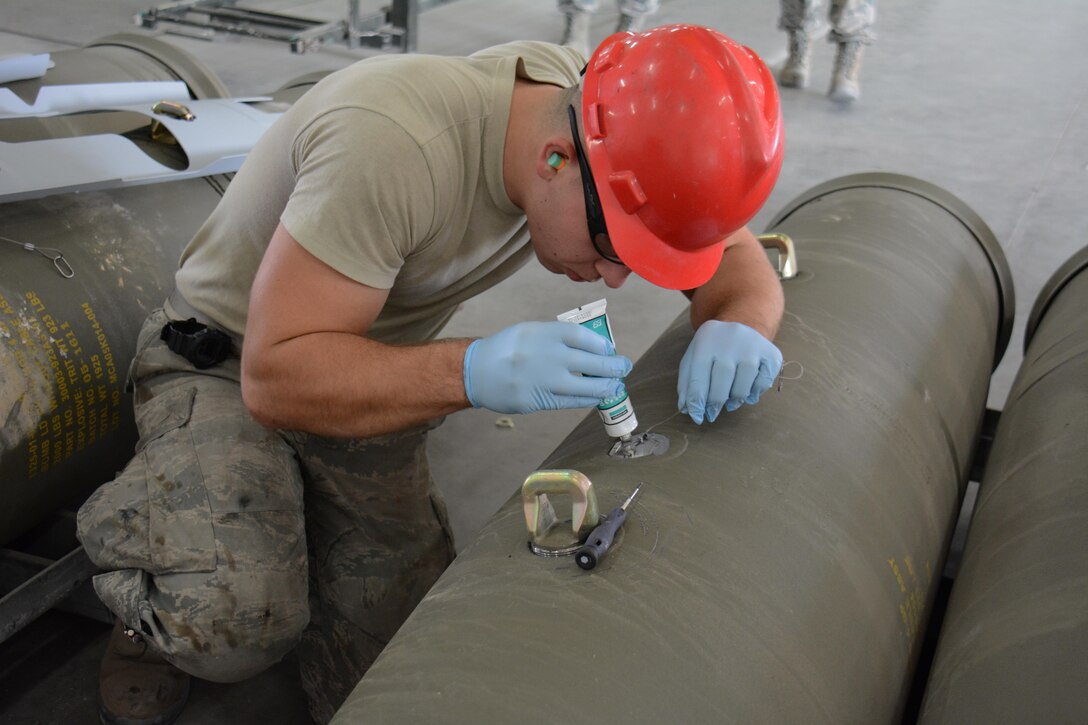 Air Force Senior Airman Michael Vespa prepares a joint attack direct munitions for transport on Al Udeid Air Base, Qatar, Dec. 17, 2015. Vespa is assigned to the 379th Expeditionary Maintenance Squadron Munitions Flight. Air Force photo by Tech. Sgt. James Hodgman 