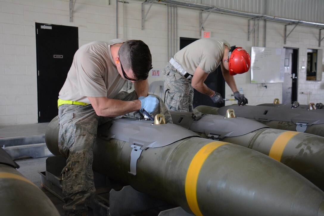 Air Force Staff Sgts. Jody Kemper, left, and Daniel Eisenhart prepare joint attack direct munitions for transport on Al Udeid Air Base, Qatar, Dec. 17, 2015. Kemper and Eisenhart are assigned to the 379th Expeditionary Maintenance Squadron Munitions Flight. Air Force photo by Tech. Sgt. James Hodgman 
