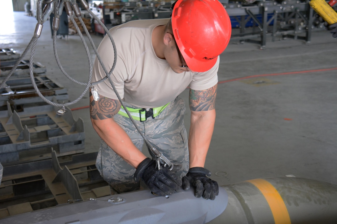 Air Force Senior Airman Justin Moyle prepares a joint attack direct munition for transport on Al Udeid Air Base, Qatar, Dec. 17, 2015. Moyle is a crew chief assigned to the 379th Expeditionary Maintenance Squadron Munitions Flight. Air Force photo by Tech. Sgt. James Hodgman