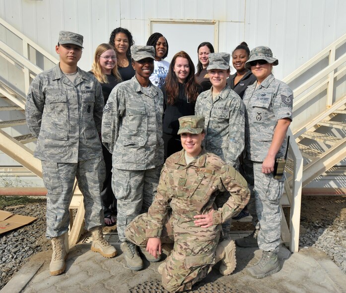 Residents of Bay A, Dorm 200 pose for a group photo outside their dormitory at an undisclosed location in Southwest Asia, Dec. 20, 2015.  The residents, 380th Air Expeditionary Security Forces Squadron Airmen, recently completed a month-long dorm renovation project to make their living areas more home-like. (U.S. Air Force photo by Staff Sgt. Kentavist P. Brackin/released)