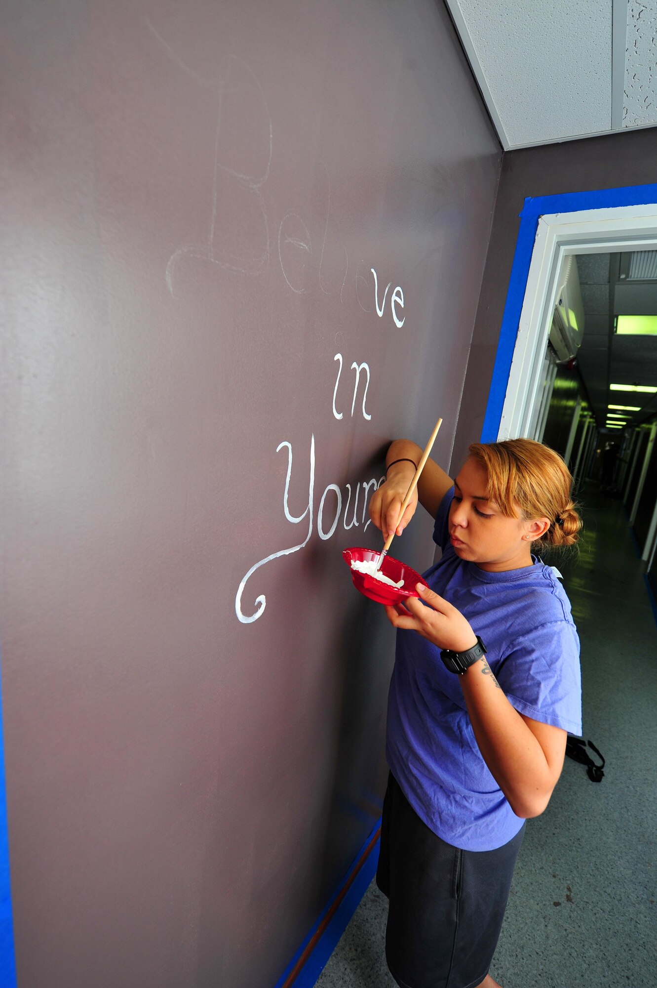 Senior Airman Joan, 380th Expeditionary Security Forces Squadron Force Protection escort, paints the corner of a door frame at an undisclosed location in Southwest Asia, Nov. 19, 2015.  The residents, 380th ESFS FP Airmen, recently completed a month-long dorm renovation project to make their living areas more home-like. (U.S. Air Force photo by Staff Sgt. Kentavist P. Brackin/released)