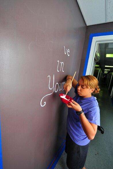 Senior Airman Joan, 380th Expeditionary Security Forces Squadron Force Protection escort, paints the corner of a door frame at an undisclosed location in Southwest Asia, Nov. 19, 2015.  The residents, 380th ESFS FP Airmen, recently completed a month-long dorm renovation project to make their living areas more home-like. (U.S. Air Force photo by Staff Sgt. Kentavist P. Brackin/released)