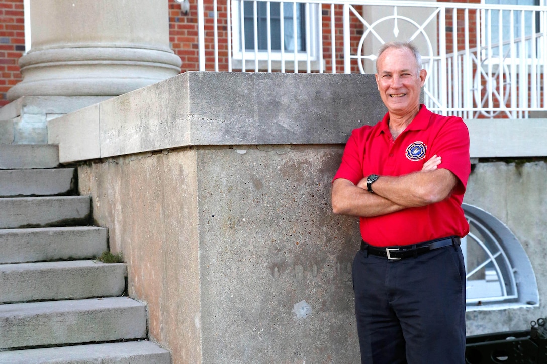 Kevin Scott, manpower, personnel and training lead for Combat Support Systems at Marine Corps Systems Command, stands in front of the command’s headquarters building aboard Marine Corps Base Quantico, Virginia. U.S. Marine Corps photo by Mathuel Browne