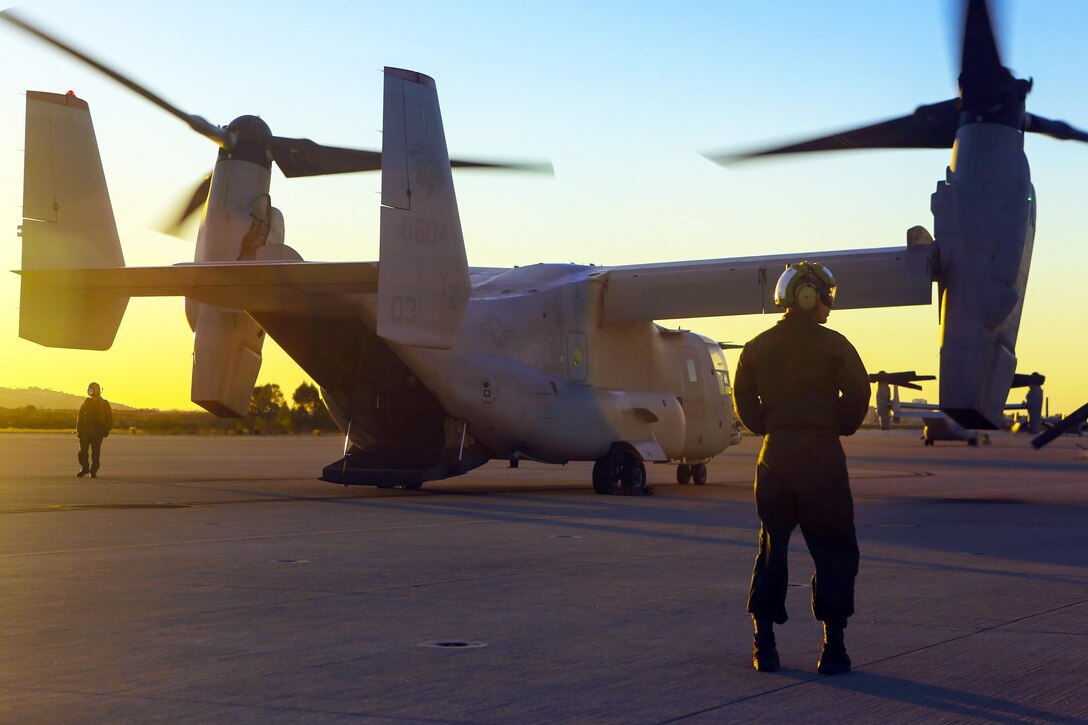 Marines perform post-flight checks on an MV-22B Osprey after aerial refueling training on Marine Corps Air Station Miramar, Calif., Dec. 16, 2015. The training allows the squadron to maintain proficiency with maneuvers. U.S. Marine Corps photo by Lance Cpl. Harley Robinson