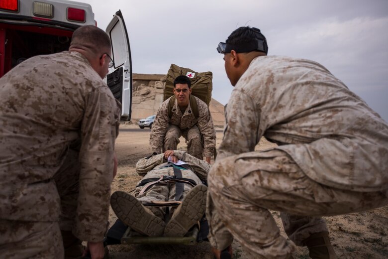 U.S. Navy Corpsmen with Special Purpose Marine Air-Ground Task Force-Crisis Response-Central Command (SPMAGTF-CR-CC) transport Cpl. Galton Hua, a simulated casualty, with Charlie Co., 1st Battalion, 7th Marine Regiment, SPMAGTF-CR-CC, during a mass casualty exercise at an undisclosed location in Southwest Asia, Dec. 23, 2015. The training familiarized U.S. joint services and partner nations with various techniques and procedures while simultaneously handling multiple casualties. (U.S. Marine Corps photo by Lance Cpl. Clarence Leake/Released)