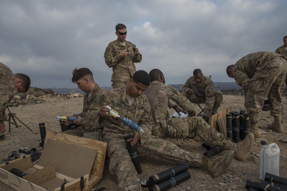 U.S. soldiers prepare mortar rounds before participating in a live-fire exercise near Camp Lemonnier, Djibouti, Dec. 16, 2015. U.S. Air Force photo by Senior Airman Cory D. Payne