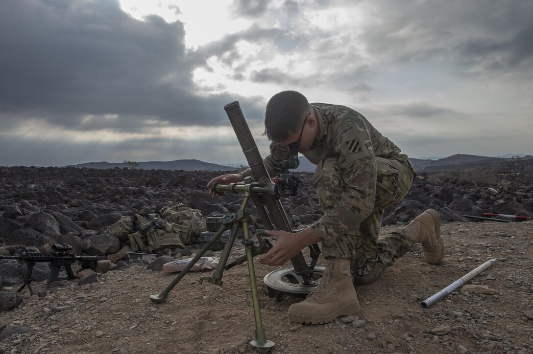 A U.S. soldier adjusts the coordinates and settings on a M224 mortar system before participating in a live-fire exercise near Camp Lemonnier, Djibouti, Dec. 16, 2015. U.S. Air Force photo by Senior Airman Cory D. Payne