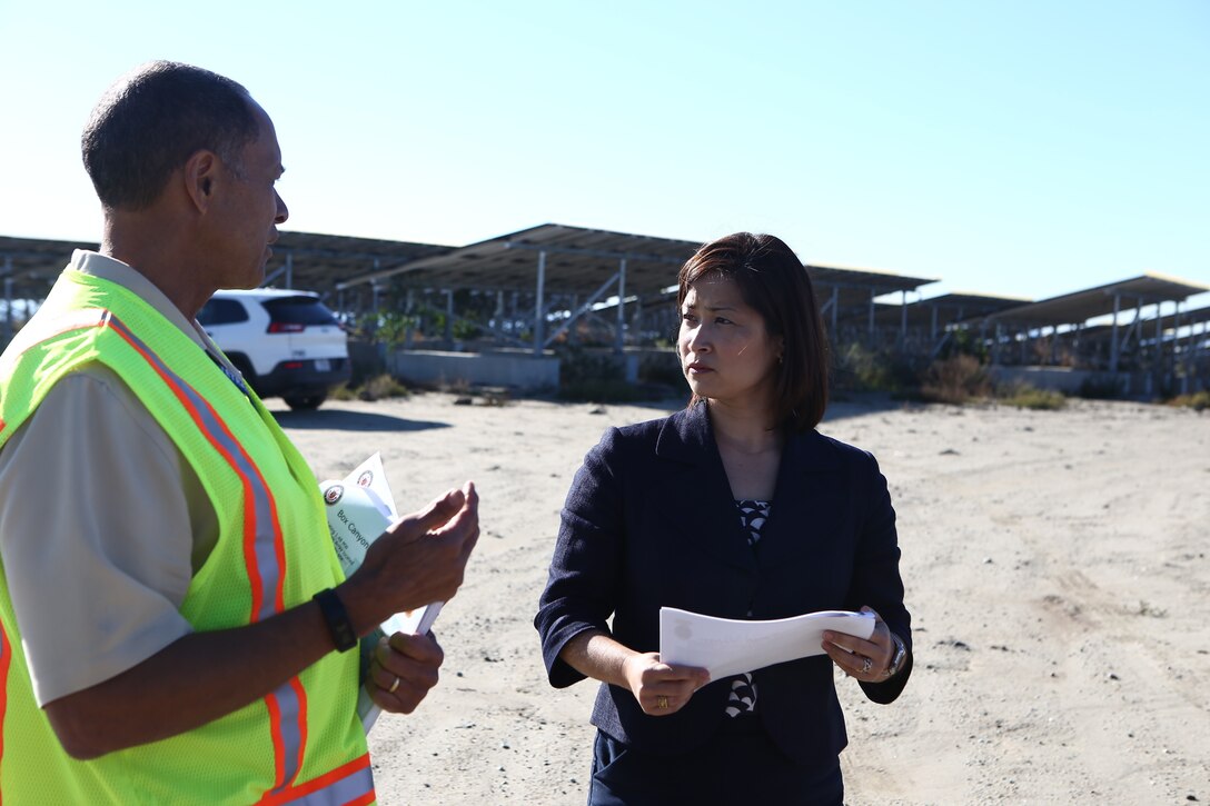 Ms. Christine Harada, Chief of Federal Sustainability Officer, right, receives a brief from Mr. Charles Howell, left, on renewable energy using Marine Corps Camp Pendleton’s Solar Photovoltaic System at Box Canyon, aboard Camp Pendleton, Calif., Dec. 29, 2015. The purpose of the visit was to provide the new White House Federal Chief Sustainability Officer information and background regarding Marine Corps Installations West-Marine Corps Base Camp Pendleton’s electric vehicle procurement, renewable energy, and how water sustainability programs support the Untied States Marine Corps mission and readiness. (U.S. Marine Corps Photo by Gunnery Sgt. Evan P. Ahlin/Released)