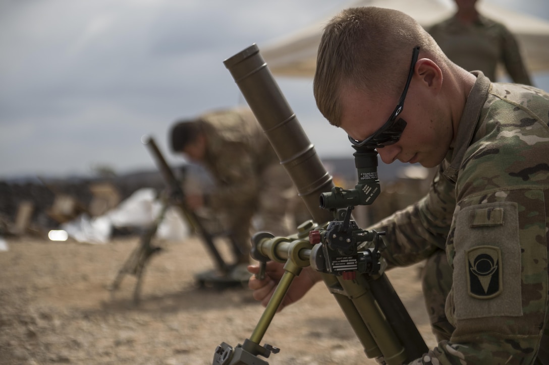 A U.S. soldier prepares a M224 mortar system during a live-fire exercise near Camp Lemonnier, Djibouti, Dec. 16, 2015. The soldier is a mortar man assigned to Company B, 2nd Battalion, 124th Infantry Battalion, Combined Joint Task Force Horn of Africa. U.S. Air Force photo by Senior Airman Cory D. Payne