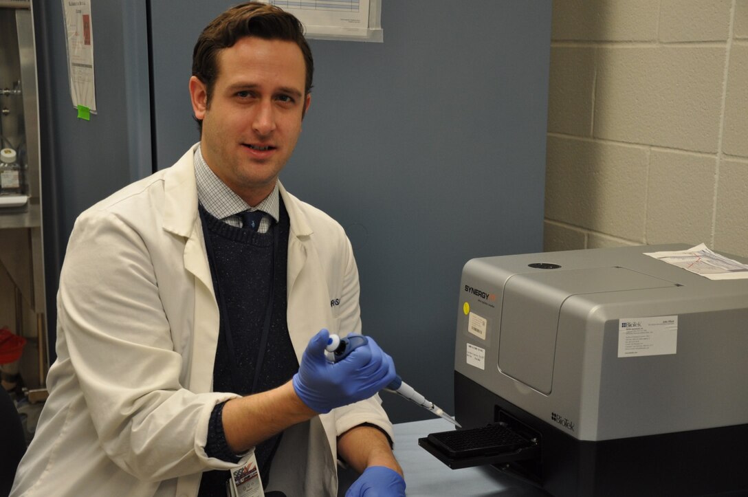Dr. Philip Vernon, researcher in NAMRU-SA’s Immunodiagnostic and Bioassay Development Department utilizes a small (15 pound) and portable microplate reader to perform a primary immuno-typing test for white blood cell activity conventionally performed with a large (350 pound) hospital flow cytometer. Utilizing this repurposed and easily portable microplate reader brings immuno-typing one step closer to becoming practical in a combat environment. (Photo from NAMRU-SA Public Affairs)