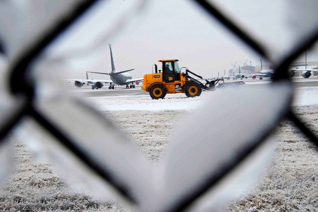 A snow plow clears the snow from the flightline after a winter storm on McConnell Air Force Base, Kan., Dec. 30, 2015. 22nd Civil Engineer Squadron personnel work to keep KC-135 Stratotankers flying to perform aerial refueling. U.S. Air Force photo by Airman Jenna K. Caldwell
