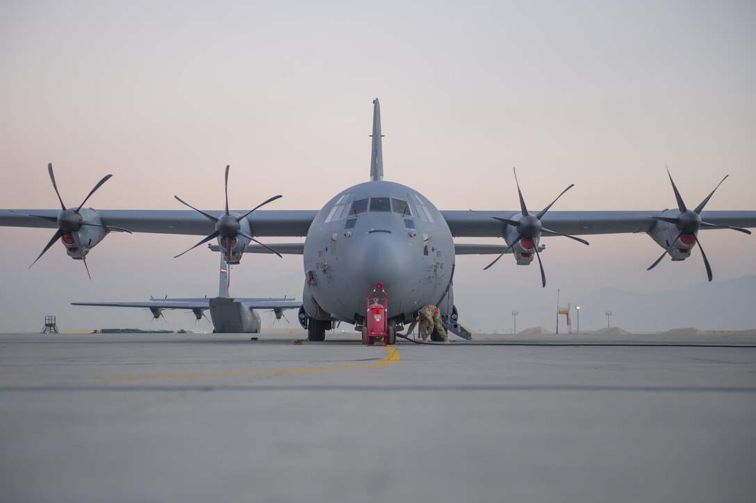 A U.S. airman works on a C-130J Super Hercules on the flightline as the sun begins to set on Bagram Airfield, Afghanistan, Dec. 28, 2015. The C-130J incorporates state-of-the-art technology to reduce manpower requirements and lower operating and support costs. The aircraft's improved engines enables the J model to climb faster and higher, fly farther at a higher cruise speed, and take off and land in a shorter distance. U.S. Air Force photo by Tech. Sgt. Robert Cloys