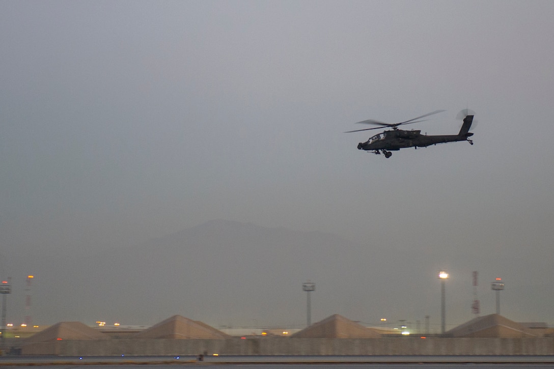 An AH-64 Apache helicopter flies over the flightline at sunset after conducting an aerial security mission over Bagram Airfield, Afghanistan, Dec. 28, 2015. The AH-64 Apache is the world’s most advanced multi-role combat helicopter and is used by the U.S. Army and a growing number of NATO defense forces. U.S. Air Force photo by Tech. Sgt. Robert Cloys