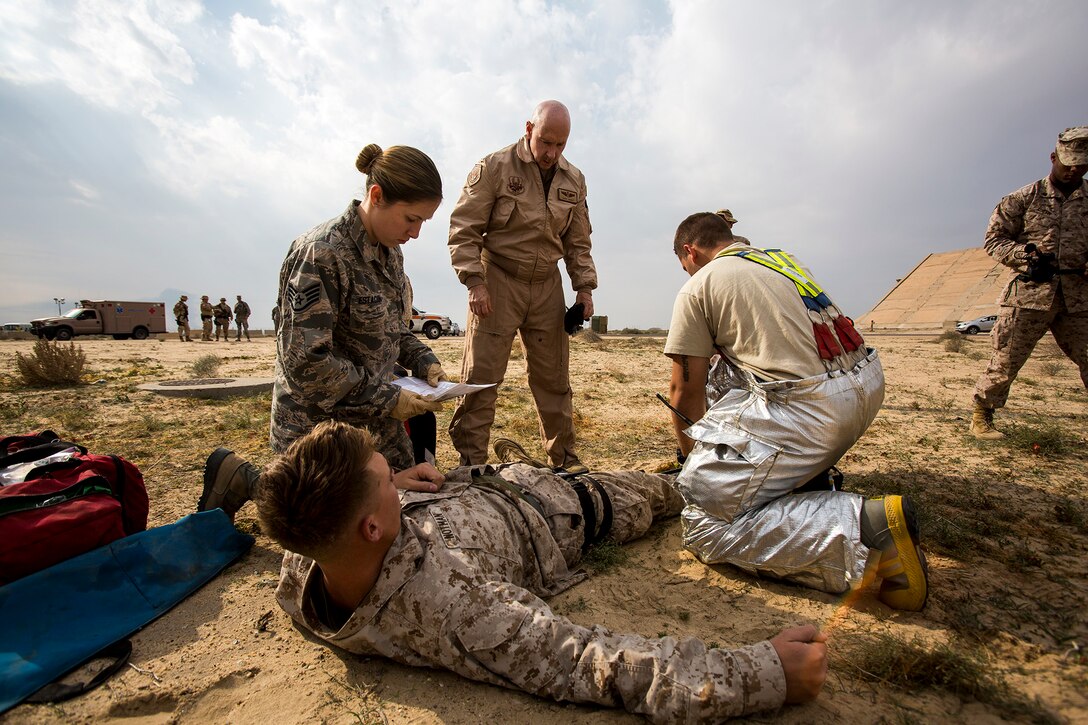 U.S. Air Force medical personnel perform initial triage on a simulated patient during a mass casualty exercise at an undisclosed location in Southwest Asia, Dec. 23, 2015. Canadian forces, U.S. airmen, soldiers, and U.S. Marines and Navy corpsmen assigned to Special Purpose Marine Air Ground Task Force – Crisis Response – Central Command, participated in the joint exercise to hone medical response capabilities. U.S. Marine Corps Photo by Sgt. Rick Hurtado