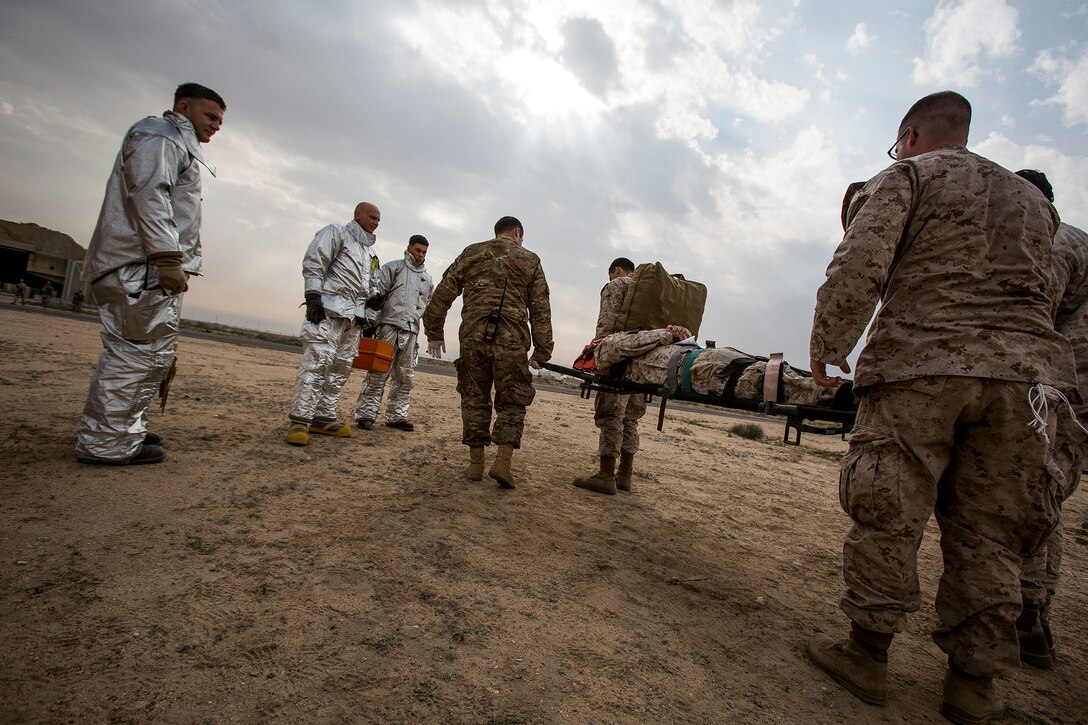 U.S. Navy and Air Force medical personnel transport a simulated patient on a stretcher during a mass casualty exercise at an undisclosed location in Southwest Asia, Dec. 23, 2015. U.S. Marine Corps Photo by Sgt. Rick Hurtado