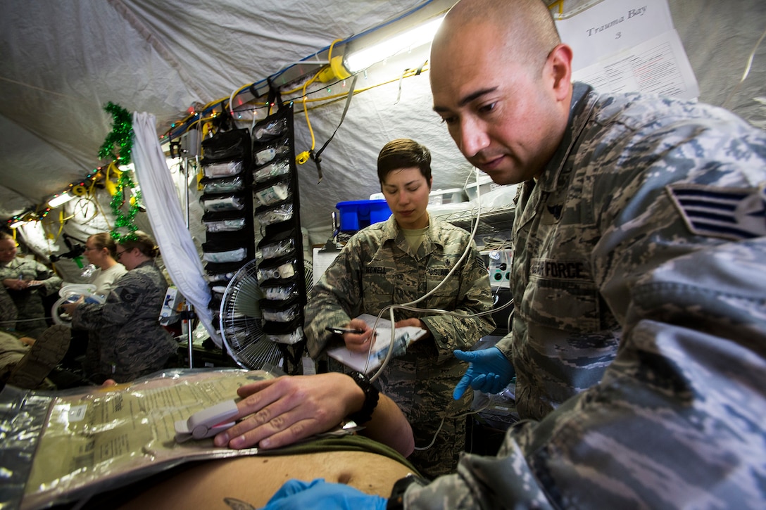 U.S. Air Force medical personnel treat a simulated patient during a mass casualty exercise at an undisclosed location in Southwest Asia, Dec. 23, 2015. U.S. Marine Corps Photo by Sgt. Rick Hurtado