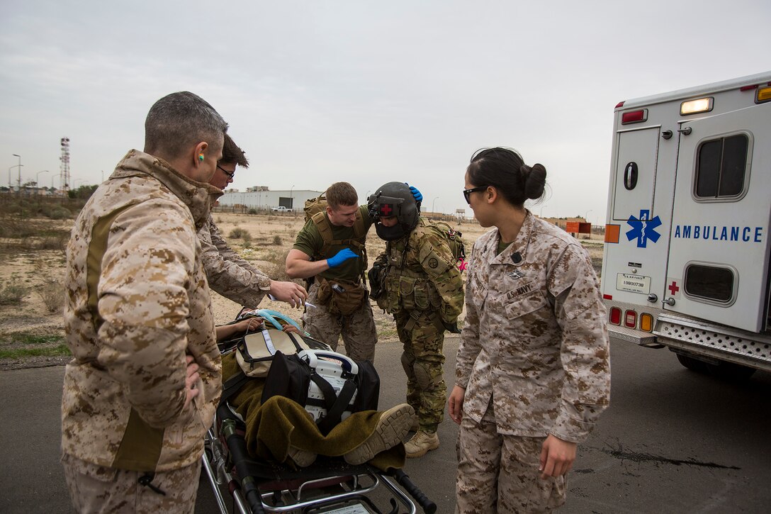 U.S. Navy and Army medical personnel prepare to load a simulated patient onto a UH-60 Black Hawk helicopter during a mass casualty exercise at an undisclosed location in Southwest Asia, Dec. 23, 2015. U.S. Marine Corps Photo by Sgt. Rick Hurtado