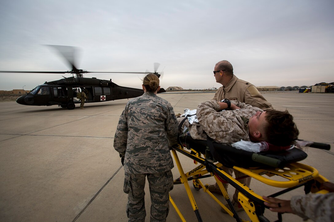 U.S. Air Force medical personnel prepare to load a simulated patient onto a UH-60 Black Hawk helicopter during a mass casualty exercise at an undisclosed location in Southwest Asia, Dec. 23, 2015. U.S. Marine Corps Photo by Sgt. Rick Hurtado