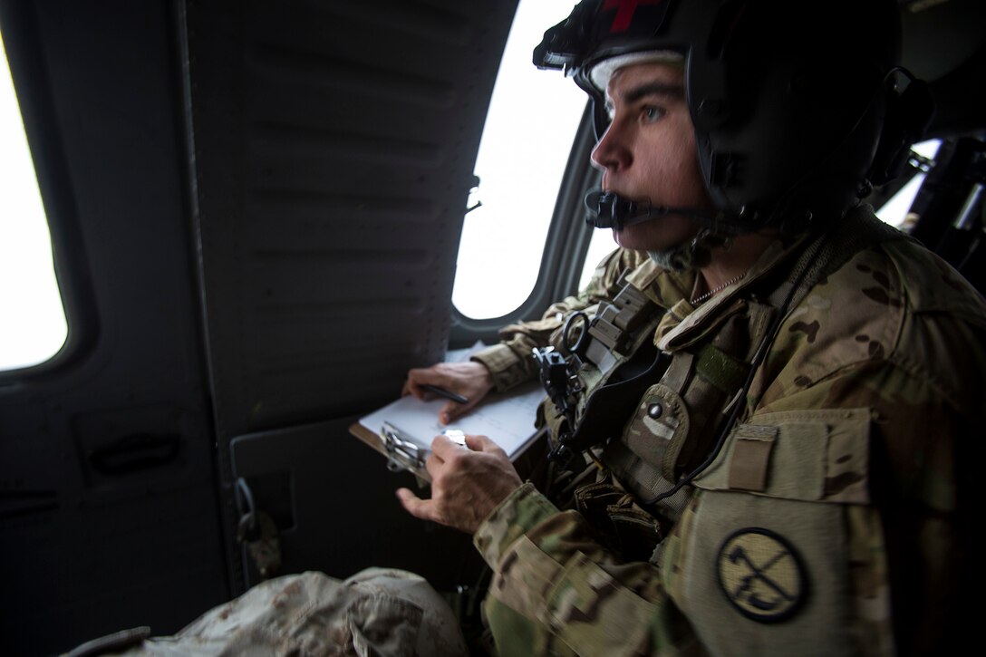 U.S. Army Sgt. Bradly Owens gathers patient information aboard a UH-60 Black Hawk helicopter during a mass casualty exercise at an undisclosed location in Southwest Asia, Dec. 23, 2015. Owens is a flight paramedic assigned to Company F, 2nd Battalion, 238th General Aviation Battalion, Medical Evacuation. U.S. Marine Corps Photo by Sgt. Rick Hurtado