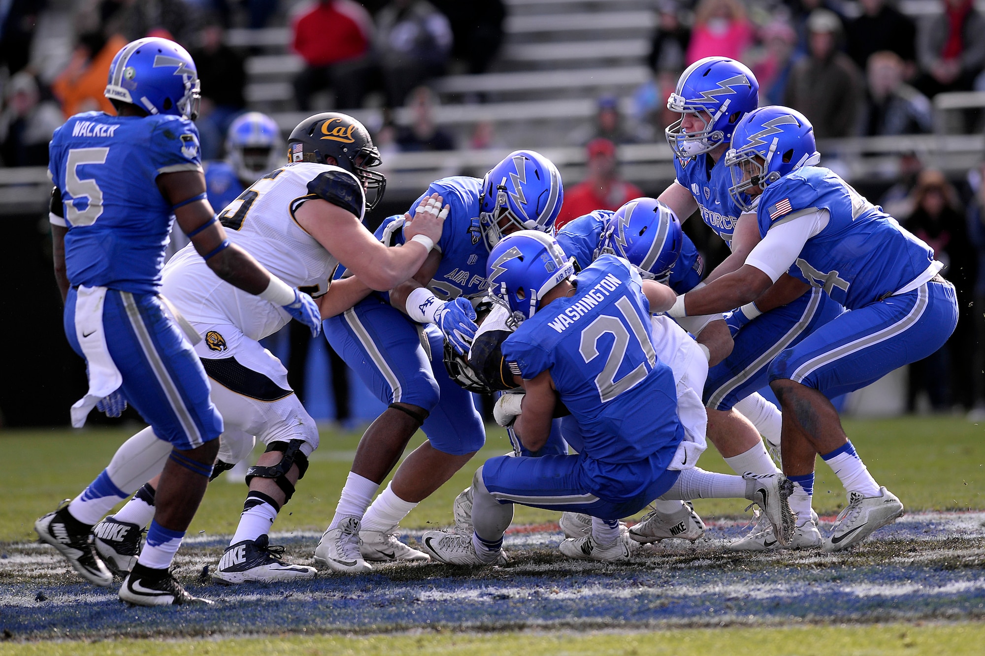 Air Force Falcons take down a California Golden Bears offensive lineman at the Armed Forces Bowl Dec. 29, 2015 in Fort Worth, Texas. The Golden Bears beat the Falcons 55-36. (U.S. Air Force photo/Mike Kaplan)