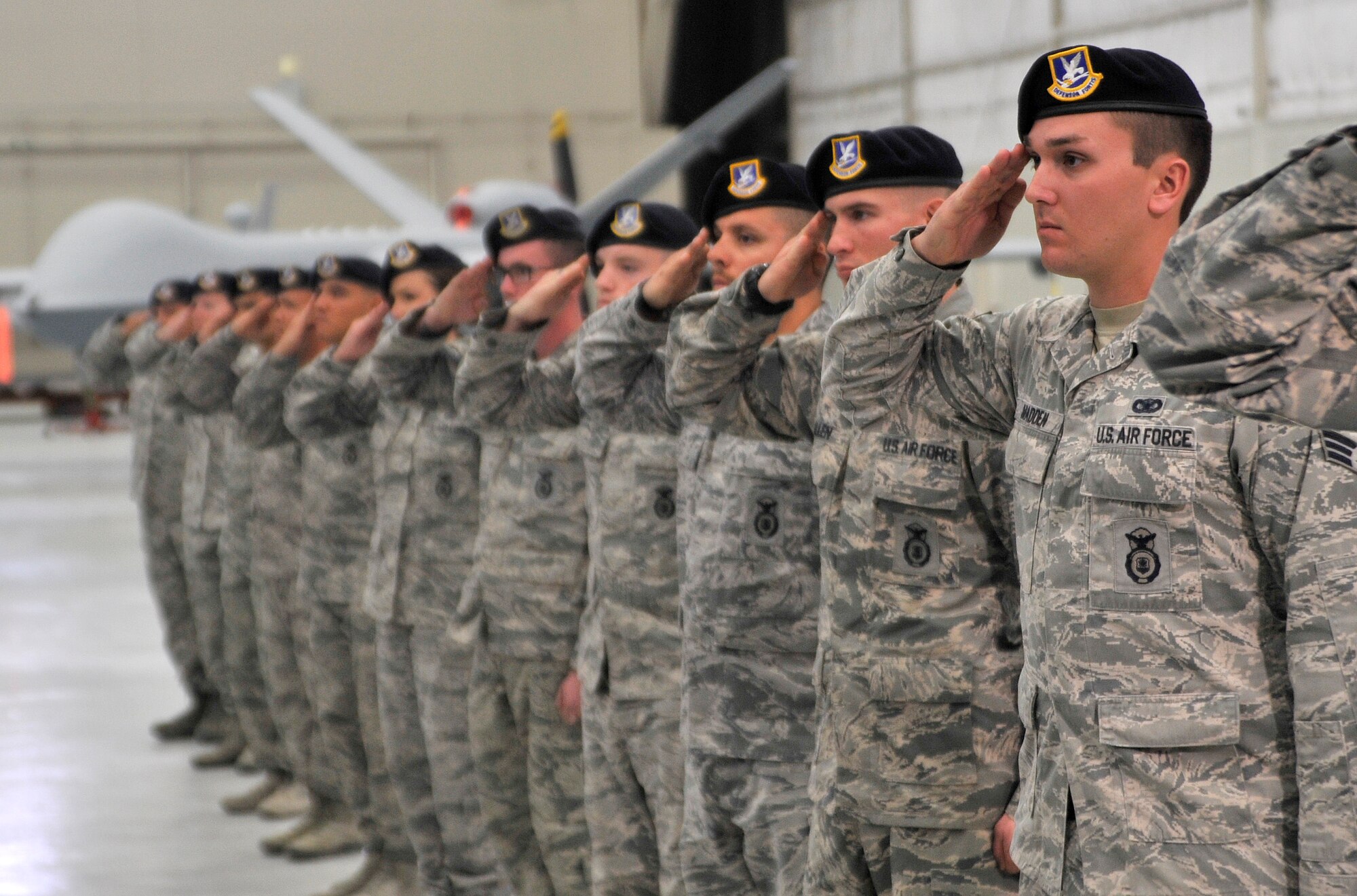Members of the 99th Ground Combat Training Squadron salute as the unit is presented with the Order of the Shield ceremony Feb. 6, 2015, at Creech Air Force Base, Nevada. The 99th GCTS is the first unit to receive the award which recognizes individuals or ACC units who have made significant contribution to security, training, and ground defense of ACC installations, missions, personnel, and resources. (U.S. Air Force photo by Airman 1st Class Christian Clausen/Released)