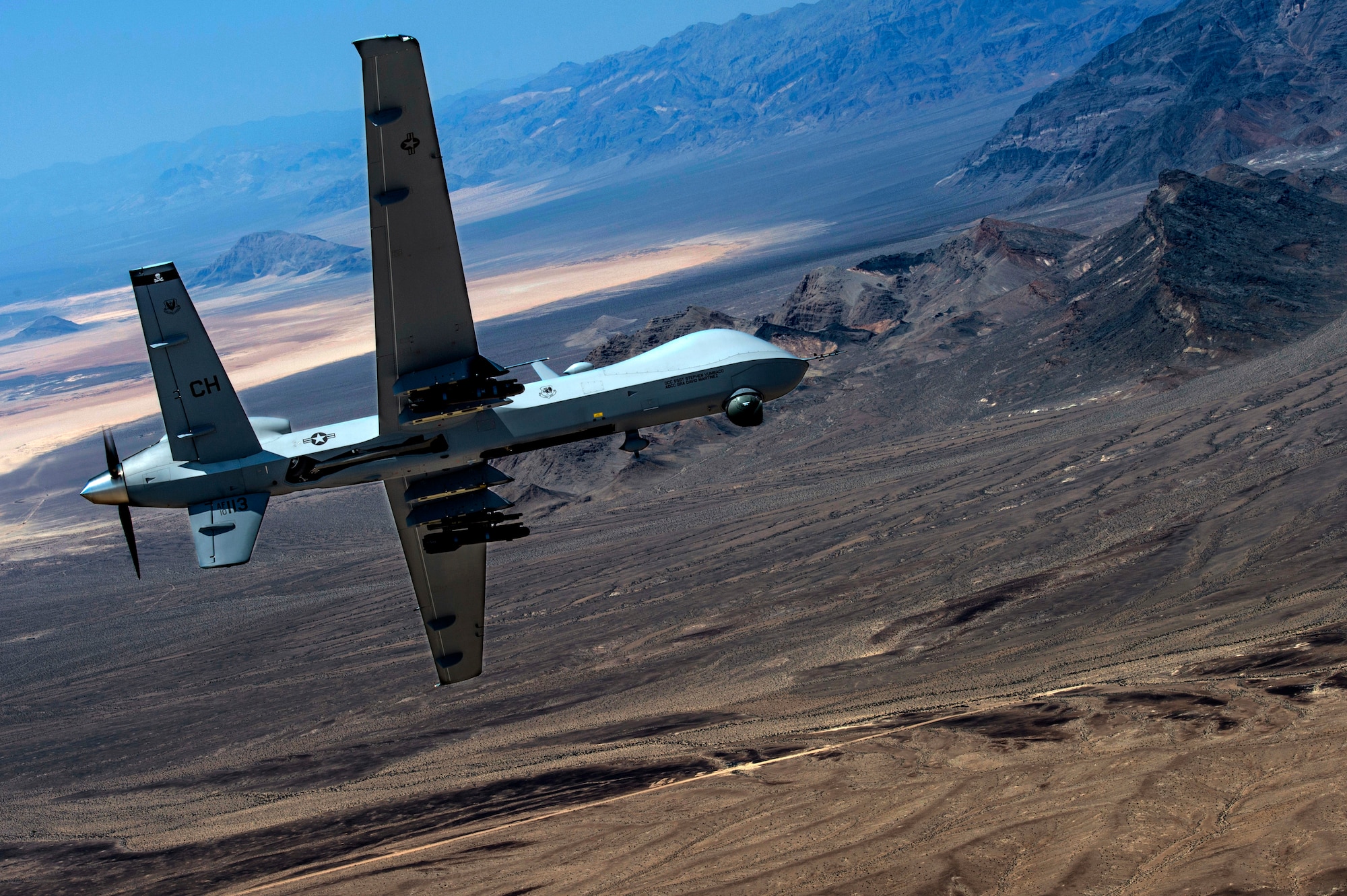 An MQ- Reaper remotely piloted aircraft performs aerial maneuvers over Creech Air Force Base, Nev., June 25, 2015. The MQ-9 Reaper is an armed, multi-mission, medium-altitude, long-endurance remotely piloted aircraft that is employed primarily as an intelligence-collection asset and secondarily against dynamic execution targets. (U.S. Air Force photo by Senior Airman Cory D. Payne/Released)