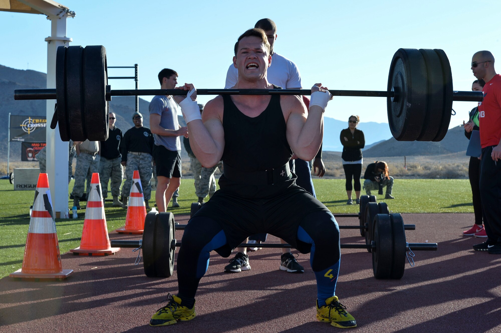 2nd Lt. Paul Baker, 432nd Maintenance Squadron maintenance flight officer-in-charge, squat cleans during the CrossFit challenge on Feb. 3, 2015, at Creech Air Force Base, Nevada. These events, along with several others are being held for the closing of the 99th Ground Combat Training Squadron. As part of the 99th GCTS closing they will receive the first Air Combat Command Security Forces Order of the Shield unit award on Feb. 6, 2015. (U.S. Air Force photo by Senior Airman Adarius Petty/Released)