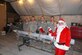 Members of the 380th Expeditionary Maintenance Squadron enjoy a visit from Santa, played by Chief Master Sgt. William, who handed out filled stockings to the troops at an undisclosed location in Southwest Asia on Christmas. When he’s not deployed, “Santa” makes his home at the 916th Air Refueling Wing, Seymour Johnson Air Force Base, North Carolina. (U.S. Air Force/courtesy photo)