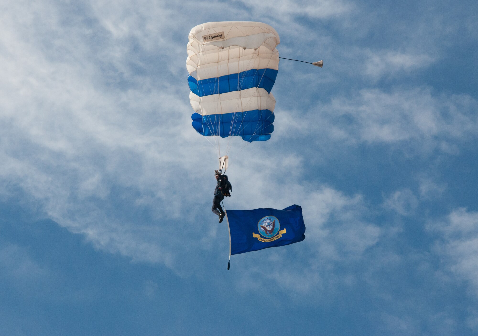 NAVAL AIR STATION FORT WORTH JOINT RESERVE BASE, Texas - A member of the Wings of Blue, the Air Force's skydiving team, descended into the Amon G. Stadium, Fort Worth, Texas Dec. 29 waving the U.S. Navy flag during the 2015 Armed Forces Bowl. The U.S. Air Force Academy and the University of California battled for the championship, but in the end the Bears beat the Falcons 55 to 36.(U. S. Air Force photo by Staff Sgt. Melissa Harvey) 
