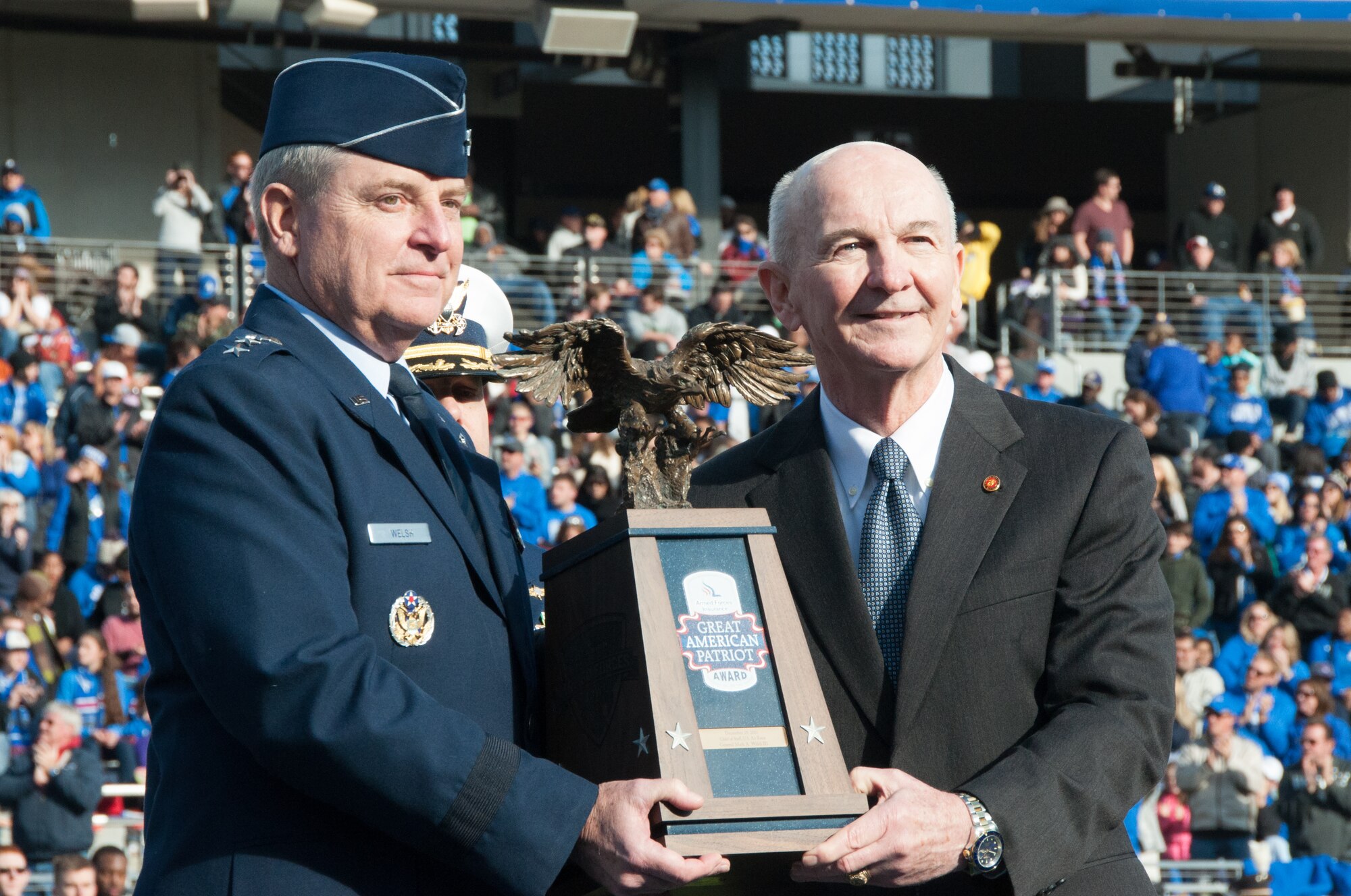 NAVAL AIR STATION FORT WORTH JOINT RESERVE BASE, Texas - Air Force Chief of Staff Gen. Mark A. Welsh III receives the Great American Patriot Award during the Lockheed Martin Armed Forces Bowl at Amon G. Carter Stadium, Fort Worth, Texas, Dec. 29. Welsh received the award in recognition of exemplary service to the United States of America. Retired Marine Gen. Garry L. Parks, chairman of Armed Forces Insurance, presented the award. (U.S. Air Force photo by Staff Sgt. Melissa Harvey)