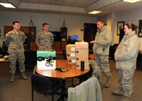 319th Air Base Wing Chaplain (Capt.) Christopher Watson speaks with Airmen from the 319th Logistics Readiness Squadron Dec. 30, 2015, on Grand Forks Air Force Base, North Dakota. Watson and members of the chapel team delivered eight Keurig coffee makers and 10 pallets of Keurig K-cups that were donated to Grand Forks AFB to different units. (U.S. Air Force photo by Airman 1st Class Ryan Sparks/Released)