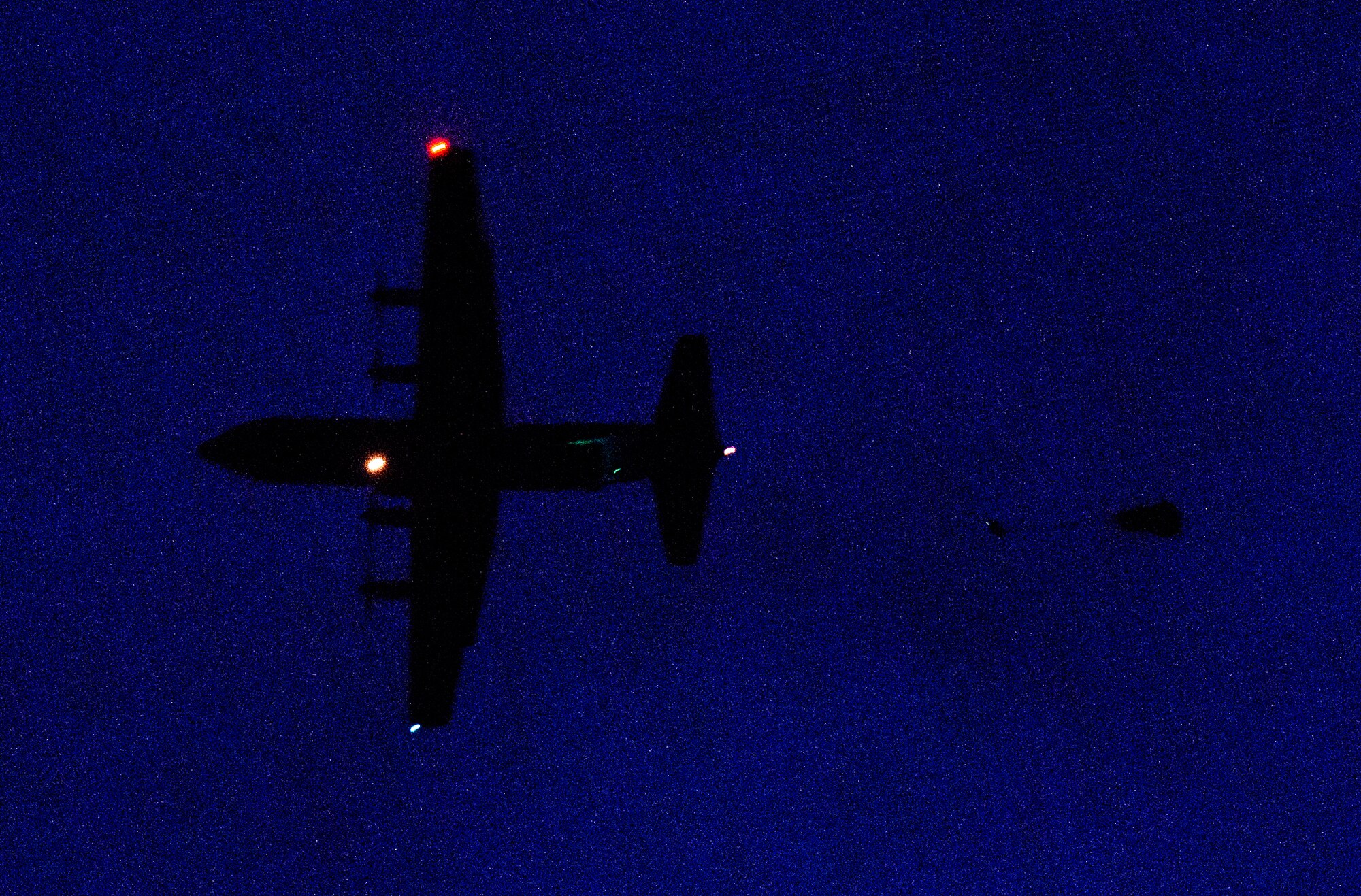 Paratroopers jump out of a C-130J Super Hercules during a nighttime training operation Dec. 18, 2015, at Alzey Drop Zone, Germany. Army paratroopers and Airmen from the 435th Air Ground Operations Wing participated in a night jump to improve their skills and build service partnership as it was the first jump with the unit for some of the Airmen. (U.S. Air Force photo/Staff Sgt. Armando A. Schwier-Morales)