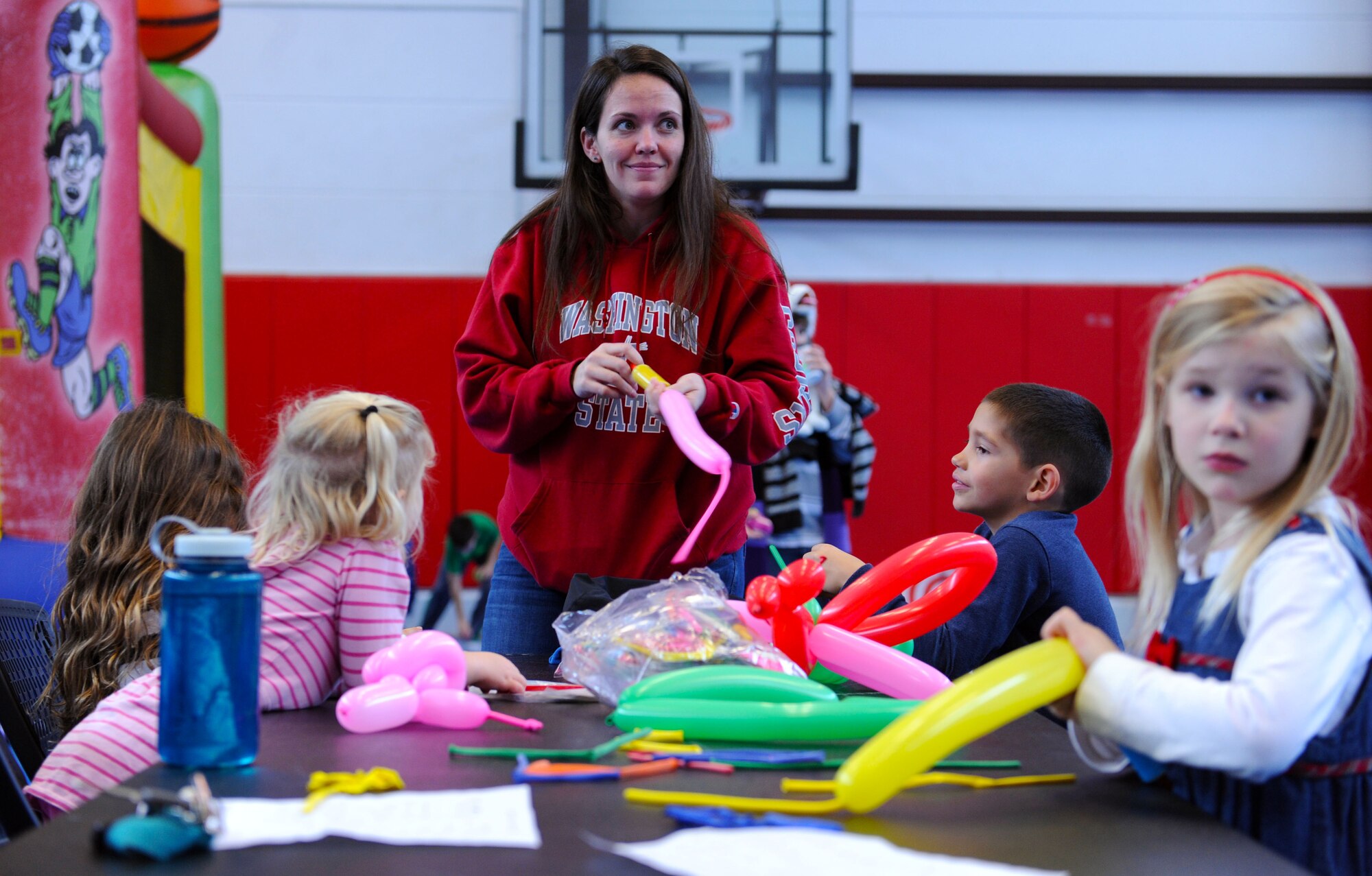 Christina Laureano makes balloon animals during the 2015 Deployed Family Members Winter Bash Dec. 21, 2015, at Vogelweh Military Complex, Germany. More than 35 families attended the event, which is intended to boost morale and ease the stress of deployment on family members. (U.S. Air Force photo/Staff Sgt. Sharida Jackson)