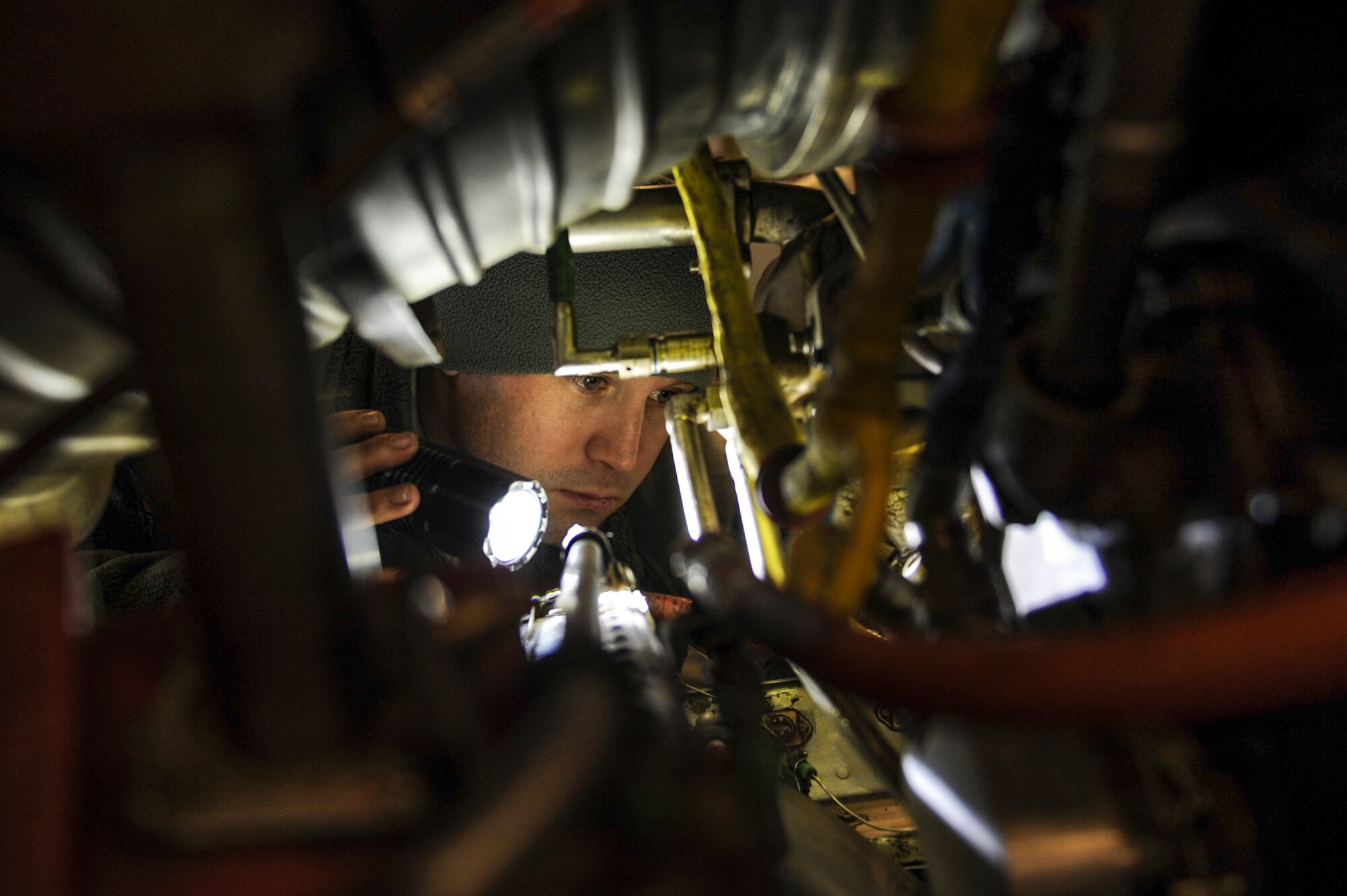 U.S. Air Force Staff Sgt. Michael White, 19th Maintenance Squadron aerospace propulsion journeyman, inspects the inside of a C-130J engine Dec. 29, 2015, at Little Rock Air Force Base, Ark. White ensured the engine was free from foreign object debris such as rubber, metal or leaves. (U.S Air Force photo/Senior Airman Harry Brexel) 