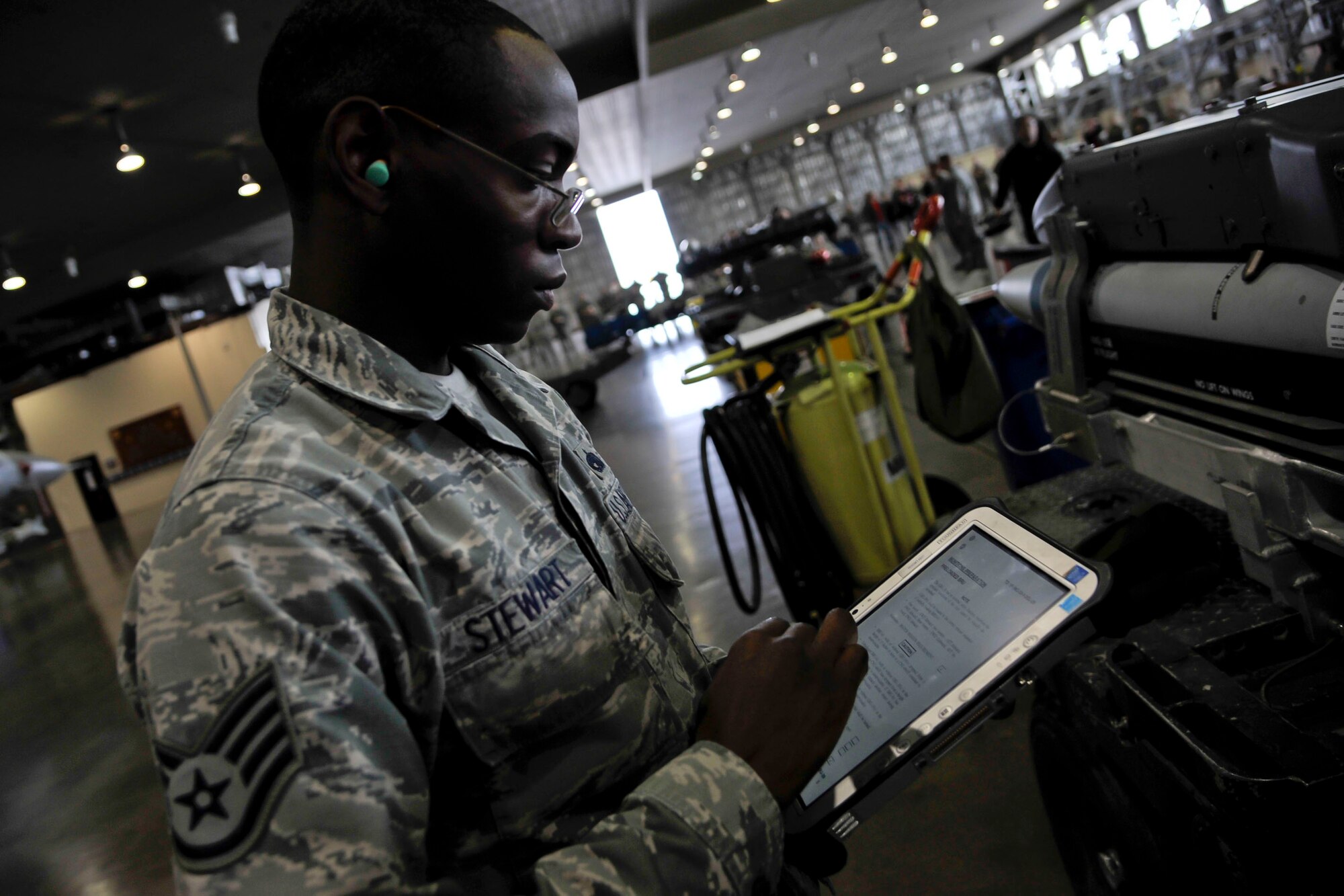 U.S. Air Force Staff Sgt. Mekai Stewart, 35th Aircraft Maintenance Squadron, 14th Aircraft Maintenance Unit weapons team chief, consults a handheld technical order during a quarterly weapons load crew competition at Misawa Air Base, Japan, Dec. 30, 2015. Stewart was among several Airmen participating in a quarterly load crew competition to see how quickly and efficiently his team could arm an F-16 Fighting Falcon. (U.S. Air Force photo by Senior Airman Patrick S. Ciccarone/Released)  