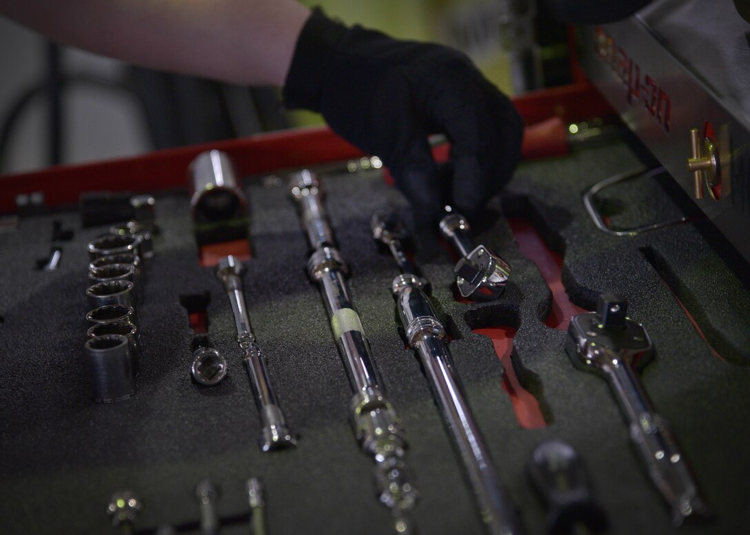 U.S. Air Force Senior Airman Donald Ramsey, 35th Aircraft Maintenance Squadron, 13th Aircraft Maintenance Unit weapons load crew member, places a tool into a toolbox during a quarterly weapons loading competition at Misawa Air Base, Japan, Dec. 30, 2015. During the competition, two teams of three Airmen were challenged to quickly install upwards of three types of armaments to a stationary F-16 Fighting Falcon in the quickest time possible. (U.S. Air Force photo by Senior Airman Deana Heitzman/Released)