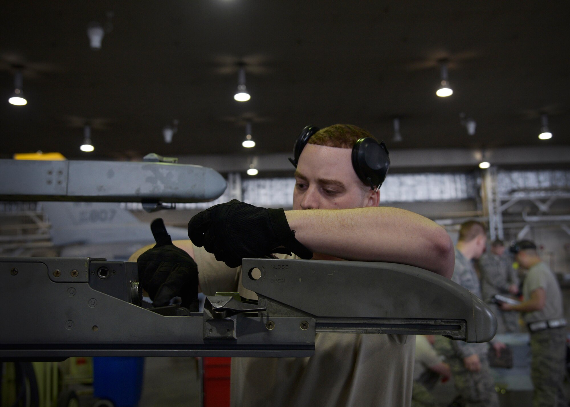 U.S. Air Force Senior Airman Donald Ramsey, 35th Aircraft Maintenance Squadron, 13th Aircraft Maintenance Unit weapons load crew member, prepares to load a weapons system during a quarterly weapons loading competition at Misawa Air Base, Japan, Dec. 30, 2015. The objective of the weapons load crew competition was to gauge how quickly and efficiently teams of Airmen are able to arm an F-16 Fighting Falcon. (U.S. Air Force photo by Senior Airman Deana Heitzman/Released)