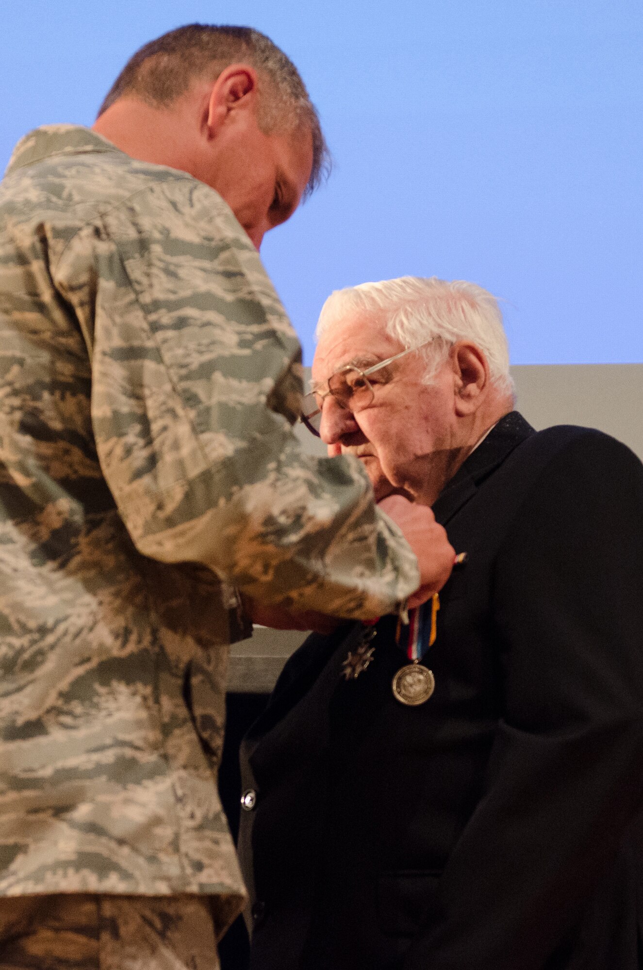 George J. Merz is presented with the French Legion of Honor by Col. Barry D. Gorter, commander of the Kentucky Air National Guard’s 123rd Airlift Wing, during a ceremony at Louisville Male High School in Louisville, Ky., Sept. 13, 2015. Merz earned the honor for his actions as a Pfc. in the U.S. Army during World War II. He saw action in both The Battle of the Bulge and the Allied Forces' D-Day invasion of Europe. (U.S. Air National Guard photo by Senior Airman Joshua Horton)